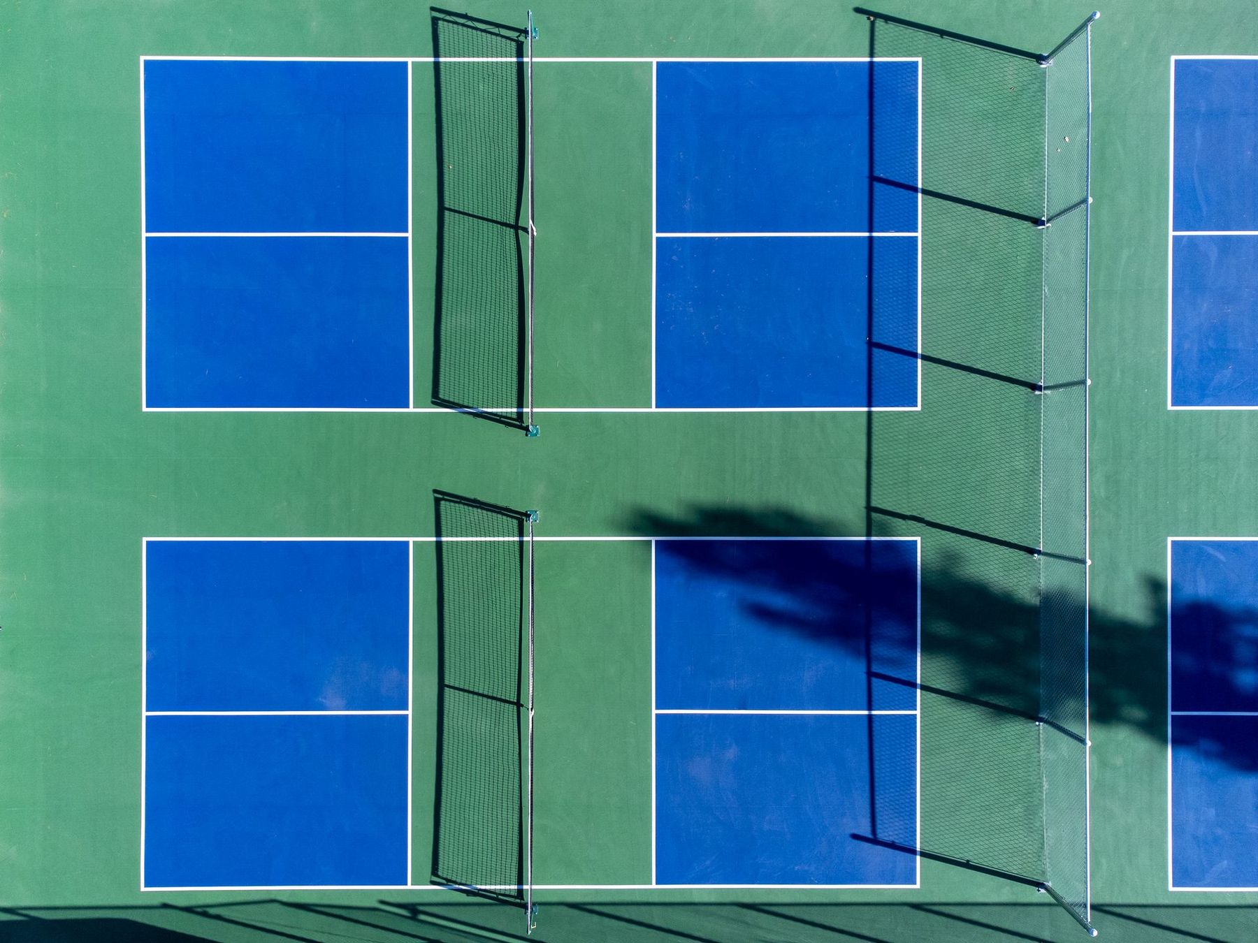 Blue and green pickleball courts seen from above