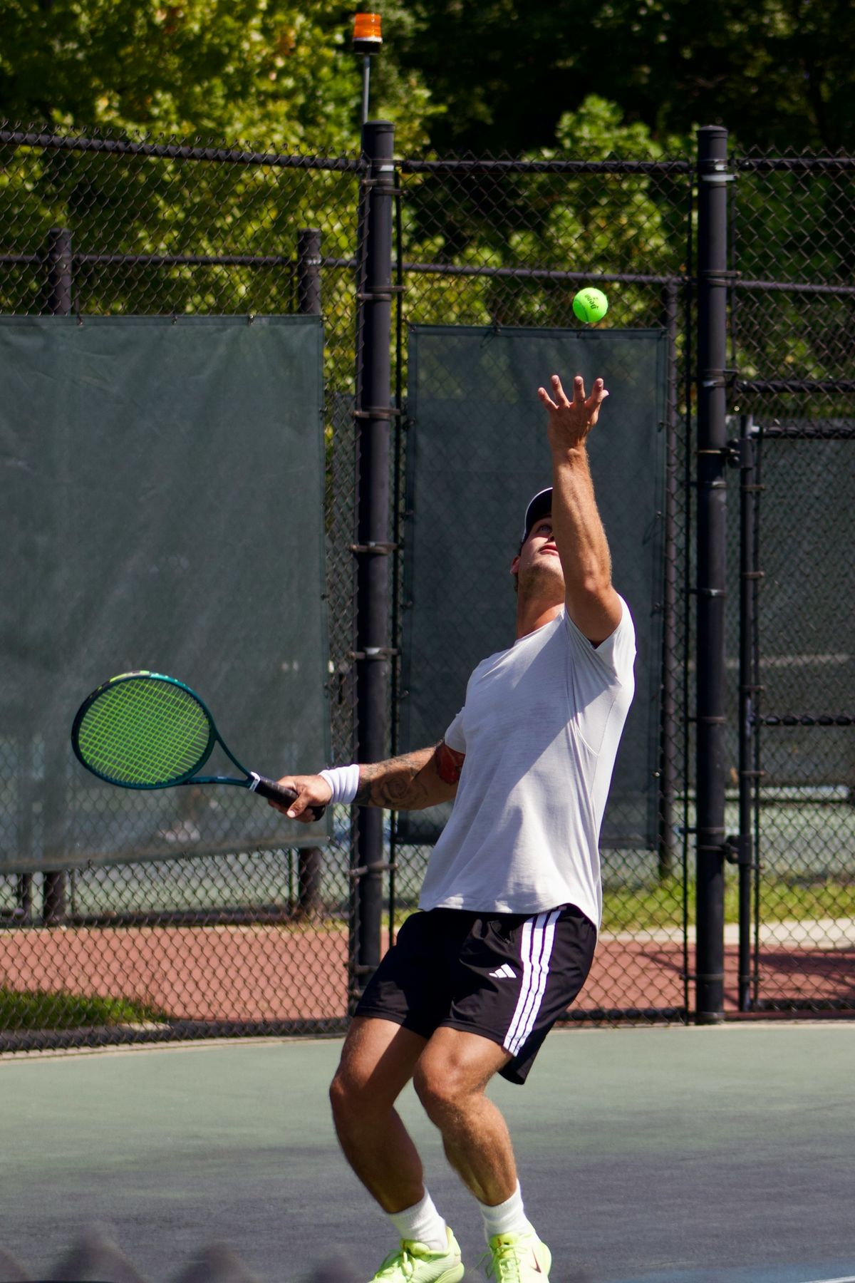 A player serving on an outdoor court