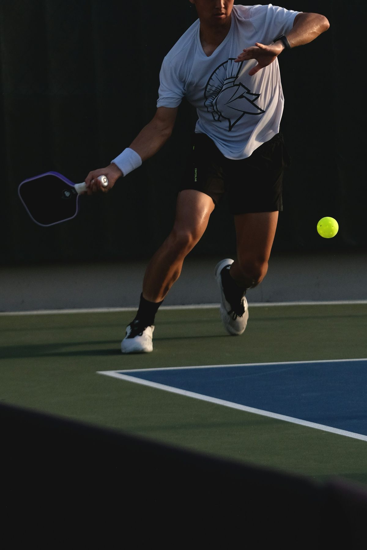 A player hitting a backhand on an outdoor court